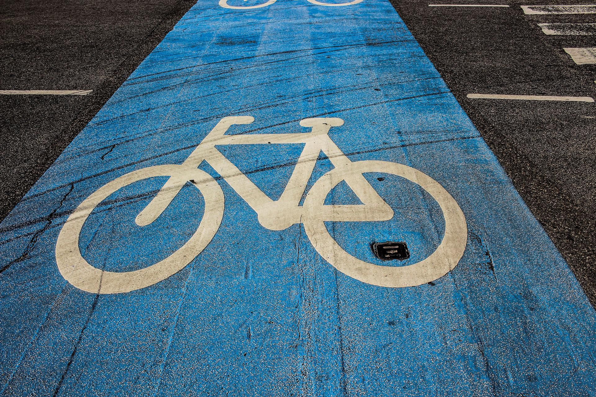 ścieżka rowerowa oznakowana znakiem białego roweru na niebieskim tle